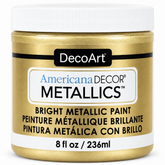 DecoArt Americana Decor Metallics Soft Gold paint bottle against a plain background