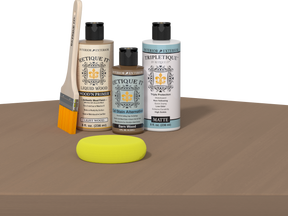 Retique It® Wood'n Finish Kit in barn wood for interior top coat with smooth finish, shown on a table application sample.