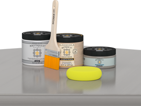 Retique It® Weathered Wood Multipurpose Kit contents with Liquid Wood primer, Weathered Wood gel stain alternative, PolyTique It® gloss exterior top coat, paintbrush, and yellow sponge displayed on a gray wood surface.