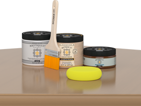 Retique It® Pecan Multipurpose Kit contents with Light Wood Liquid Wood primer, Pecan gel stain alternative, PolyTique It® gloss exterior top coat, paintbrush, and yellow sponge displayed on a wood surface.