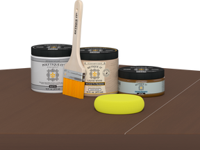 Retique It® Dark Oak Multipurpose Kit contents with Liquid Wood primer, Dark Oak gel stain alternative, PolyTique It® matte exterior top coat, paintbrush, and yellow sponge displayed on a dark wood surface.
