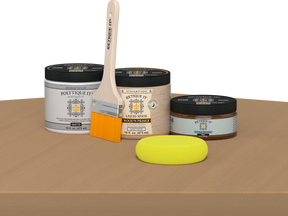 Retique It® Pecan Multipurpose Kit contents with Light Wood Liquid Wood primer, Pecan gel stain alternative, PolyTique It® matte exterior top coat, paintbrush, and yellow sponge displayed on a wood surface.