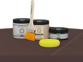 Retique It® Java Multipurpose Kit contents with Liquid Wood primer, Java gel stain alternative, PolyTique It® matte exterior top coat, paintbrush, and yellow sponge displayed on a dark wood surface.