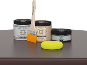 Retique It® Java Multipurpose Kit contents with Liquid Wood primer, Java gel stain alternative, PolyTique It® satin exterior top coat, paintbrush, and yellow sponge displayed on a dark wood surface.