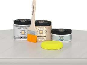 Retique It® White Wash Multipurpose Kit contents with Liquid Wood primer, White Wash gel stain alternative, PolyTique It® satin exterior top coat, paintbrush, and yellow sponge displayed on a white wood surface.
