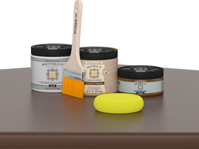 Retique It® Dark Oak Multipurpose Kit contents with Liquid Wood primer, Dark Oak gel stain alternative, PolyTique It® satin exterior top coat, paintbrush, and yellow sponge displayed on a dark wood surface.