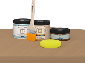 Retique It® Pecan Multipurpose Kit contents with Light Wood Liquid Wood primer, Pecan gel stain alternative, Tripletique matte interior top coat, paintbrush, and yellow sponge displayed on a wood surface.