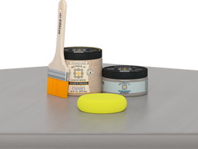 Retique It® Weathered Wood Multipurpose Kit contents with Liquid Wood primer, Weathered Wood gel stain alternative, paintbrush, and yellow sponge displayed on a gray wood surface.