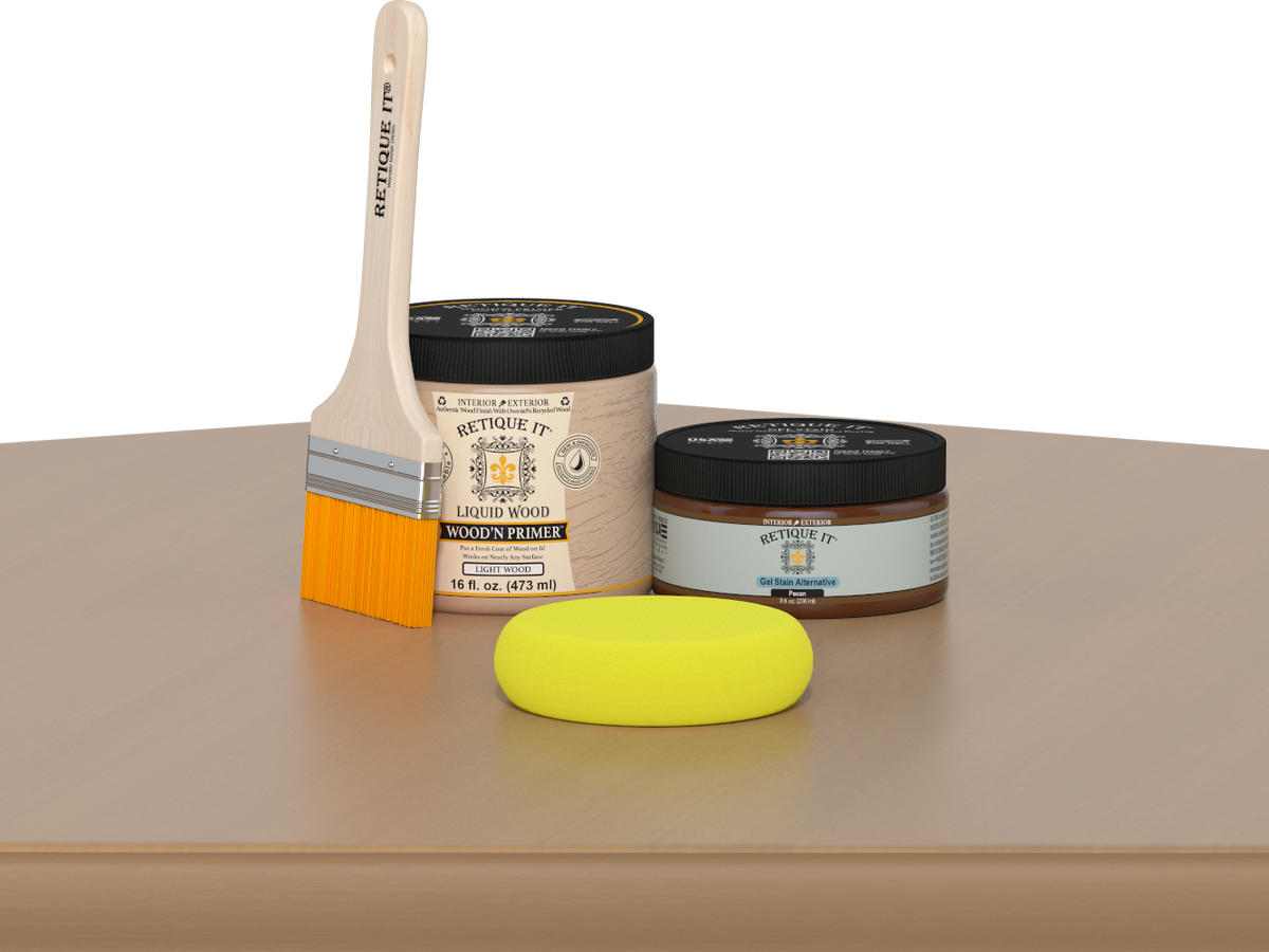 Retique It® Pecan Multipurpose Kit contents with Light Wood Liquid Wood primer, Pecan gel stain alternative, paintbrush, and yellow sponge displayed on a light wood surface.