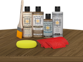 Retique It Wood'n Finish Kit in Barn Wood with exterior topcoat, featuring wood panels and finishing tools on a table surface.