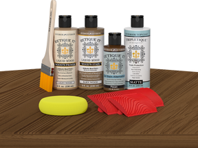Retique It® Barn Wood Wood'n Kit with Light Wood Primer, Barn Wood Wood'n Stain, Matte TripleTique Top Coat, Pecan Gel Stain Alternative, yellow sponge, red graining tool, and brush.