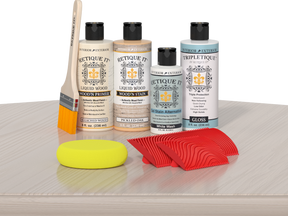 Sun-bleached Wood'n Finish Kit by Retique It® for interior wood projects, shown on a table with wood top coat application.