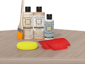Retique It Wood'n Finish Kit for fireplaces, Sun Bleached color, showcasing the wood finish applied to a mantel on a table.