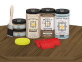 Retique It Wood'n Finish Kit with four large barn wood stain bottles on a table, featuring matte finish for wood projects.