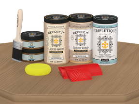 Retique It® Wood'n Finish Kit with four large pickled oak stain bottles for wood finishing, matte finish shown on tabletop.
