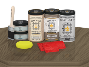 Retique It® Wood'n Finish front door kit in weathered wood stain with glossy finish, shown on a table.