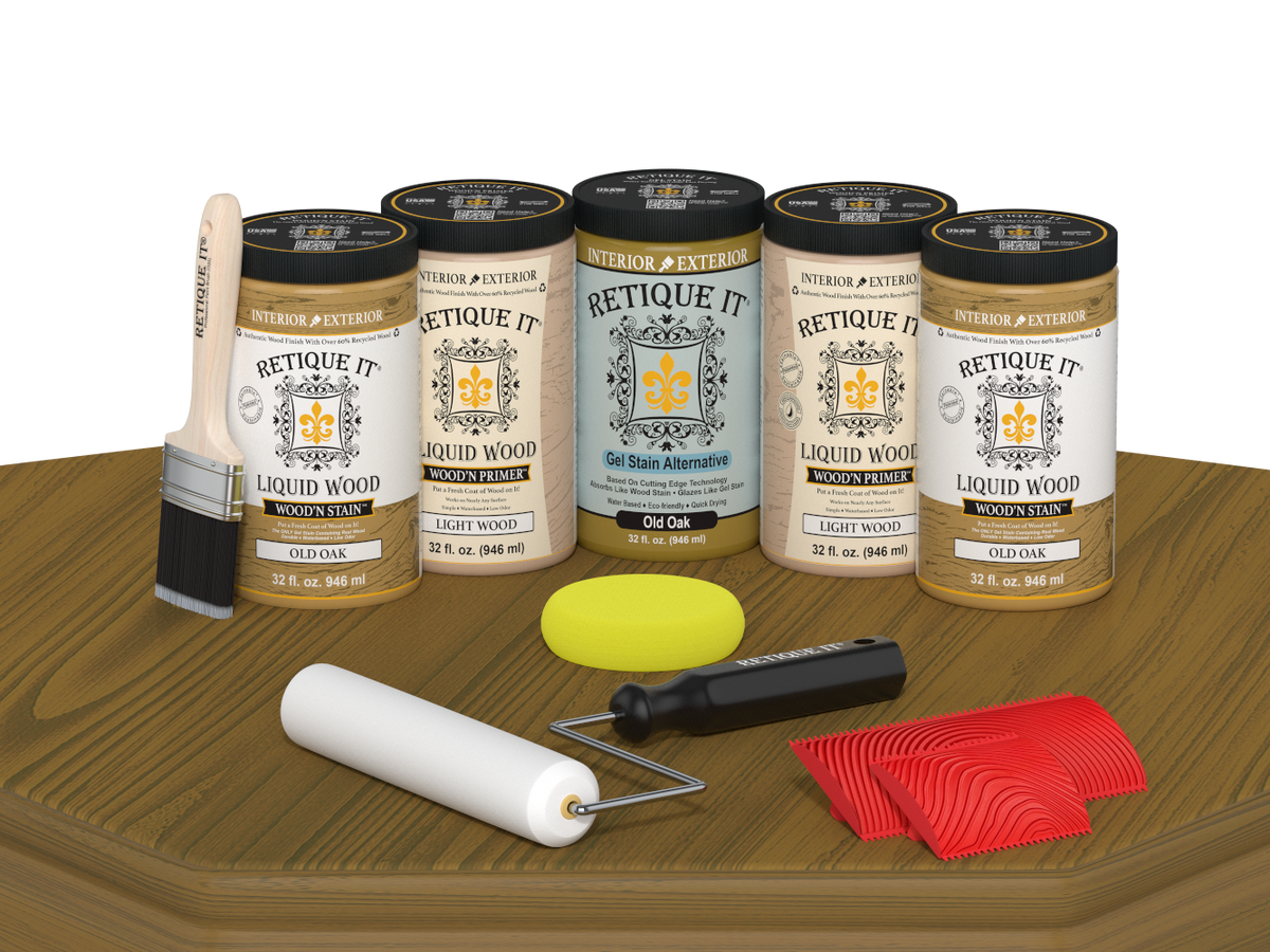Retique It Old Oak Wood'n Kit featuring Old Oak Liquid Wood stain, Light Wood primer, Old Oak Gel Stain Alternative, paint brush, white roller, yellow sponge, and red graining tools displayed on a wood tabletop.