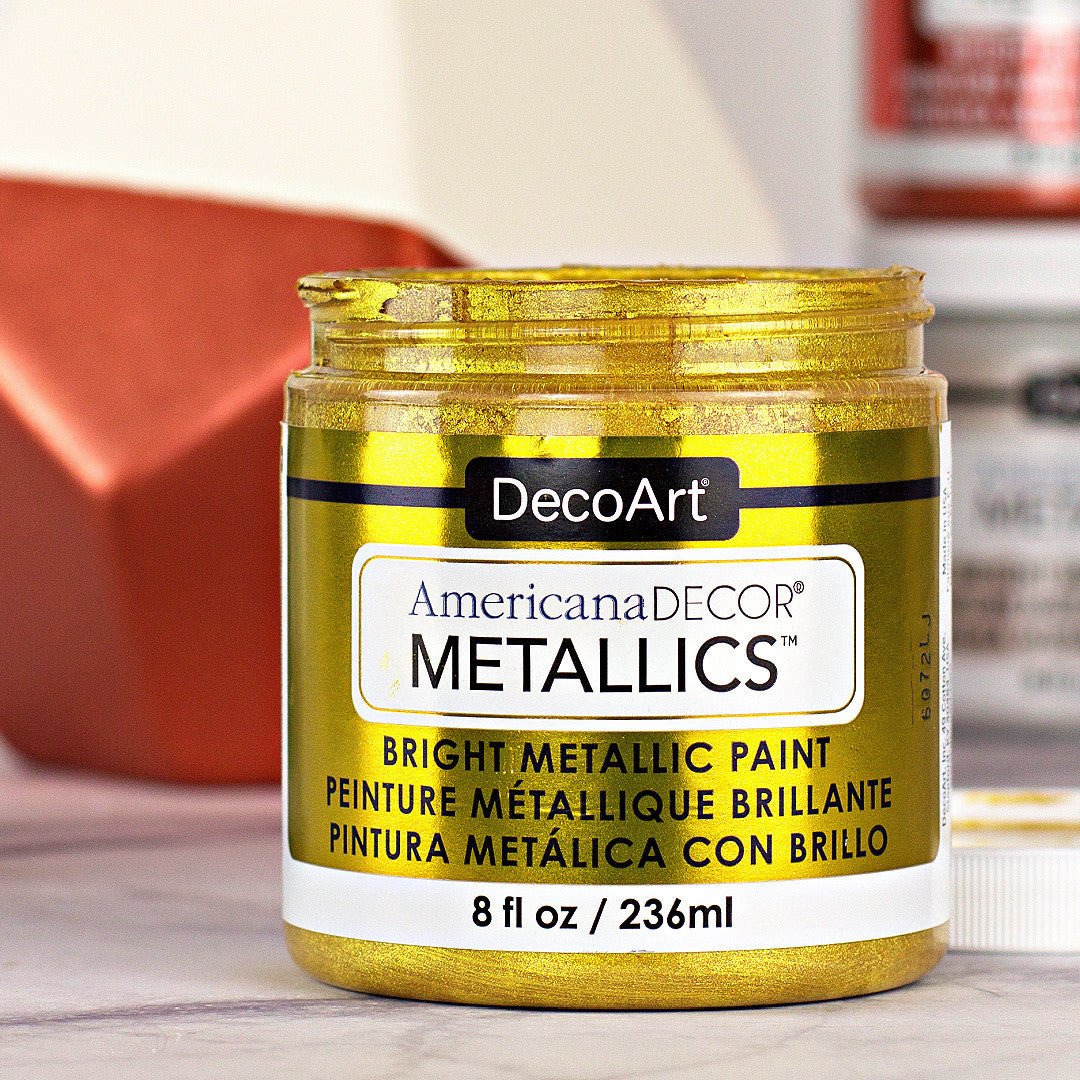 8 oz bottle of DecoArt Americana Decor Metallics Pearl paint showing the metallic pearl finish and branding.