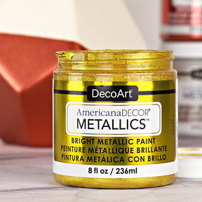 8 oz bottle of DecoArt Americana Decor Metallics Pearl paint showing the metallic pearl finish and branding.